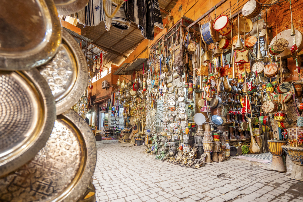Tourism in Marrakech in a street in Medina Narrow street in medina of Marrakech full of shops with metal and wooden art